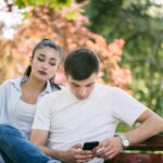 Young woman Spy on Boyfriend Cell Phone