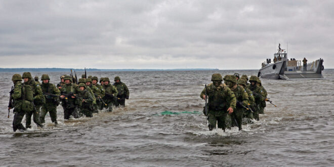 US Navy 100615 M 0884D 033 Estonian soldiers wade ashore during a combined U.S. and Estonia amphibious assault training exercise during Baltic Operations BALTOPS 2010