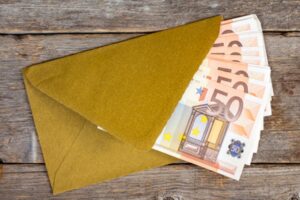 Golden envelope with Euro bills