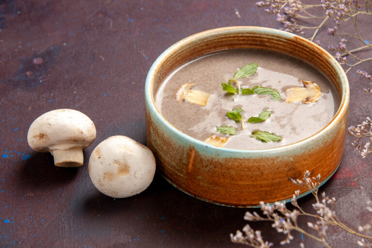 front-close-view-delicious-mushroom-soup-inside-plate-dark-space