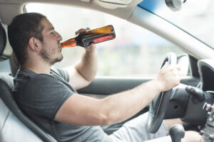 man-drinking-beer-car