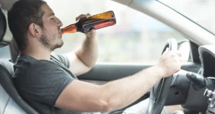 man drinking beer car