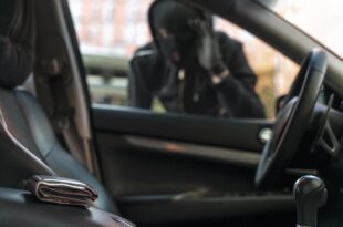 close up man trying break into car