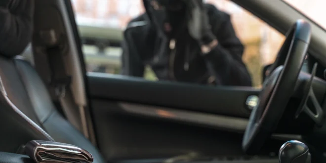 close up man trying break into car